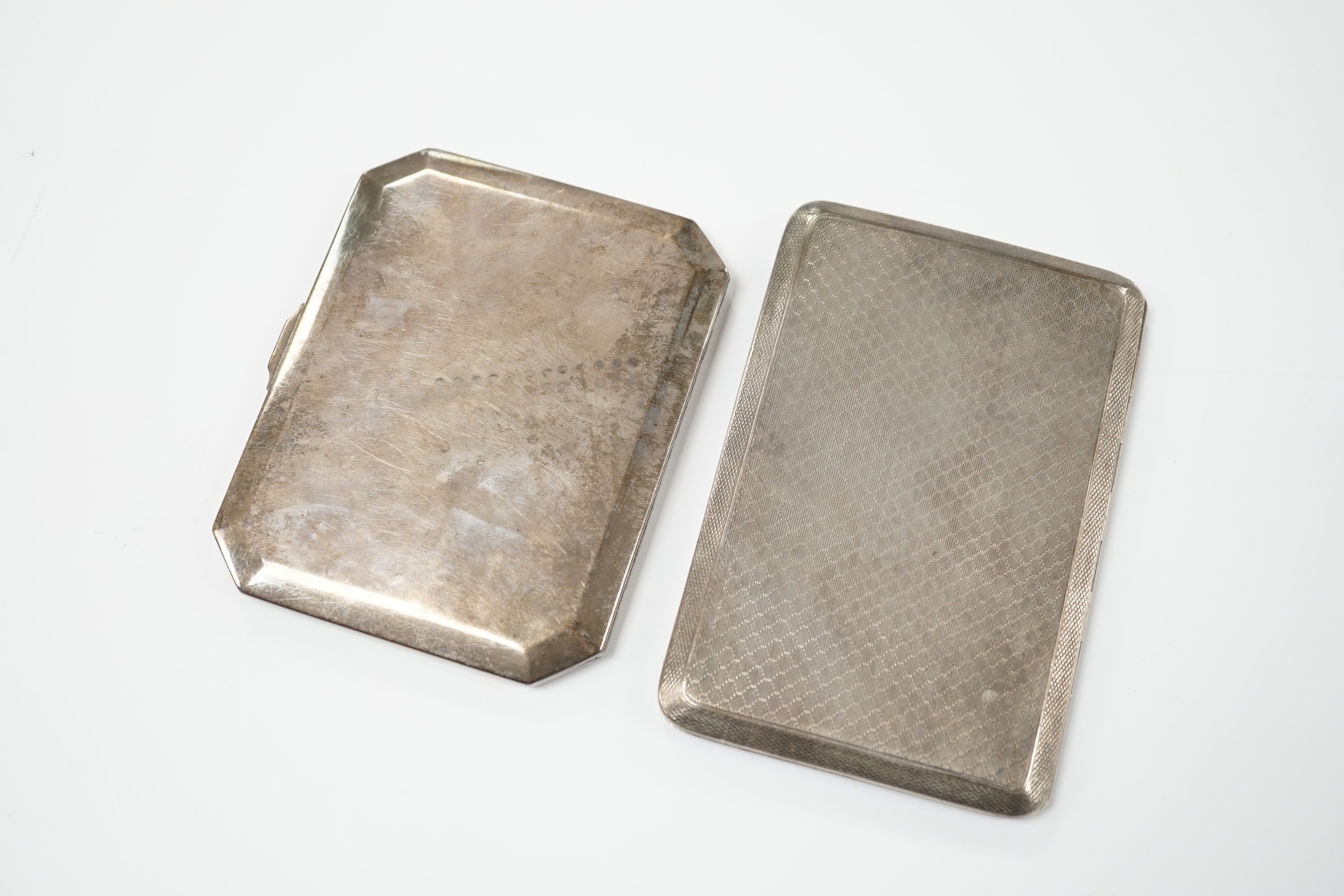 A George V engine turned silver cigarette case, 183 grams, and a Thai white metal and niello cigarette case